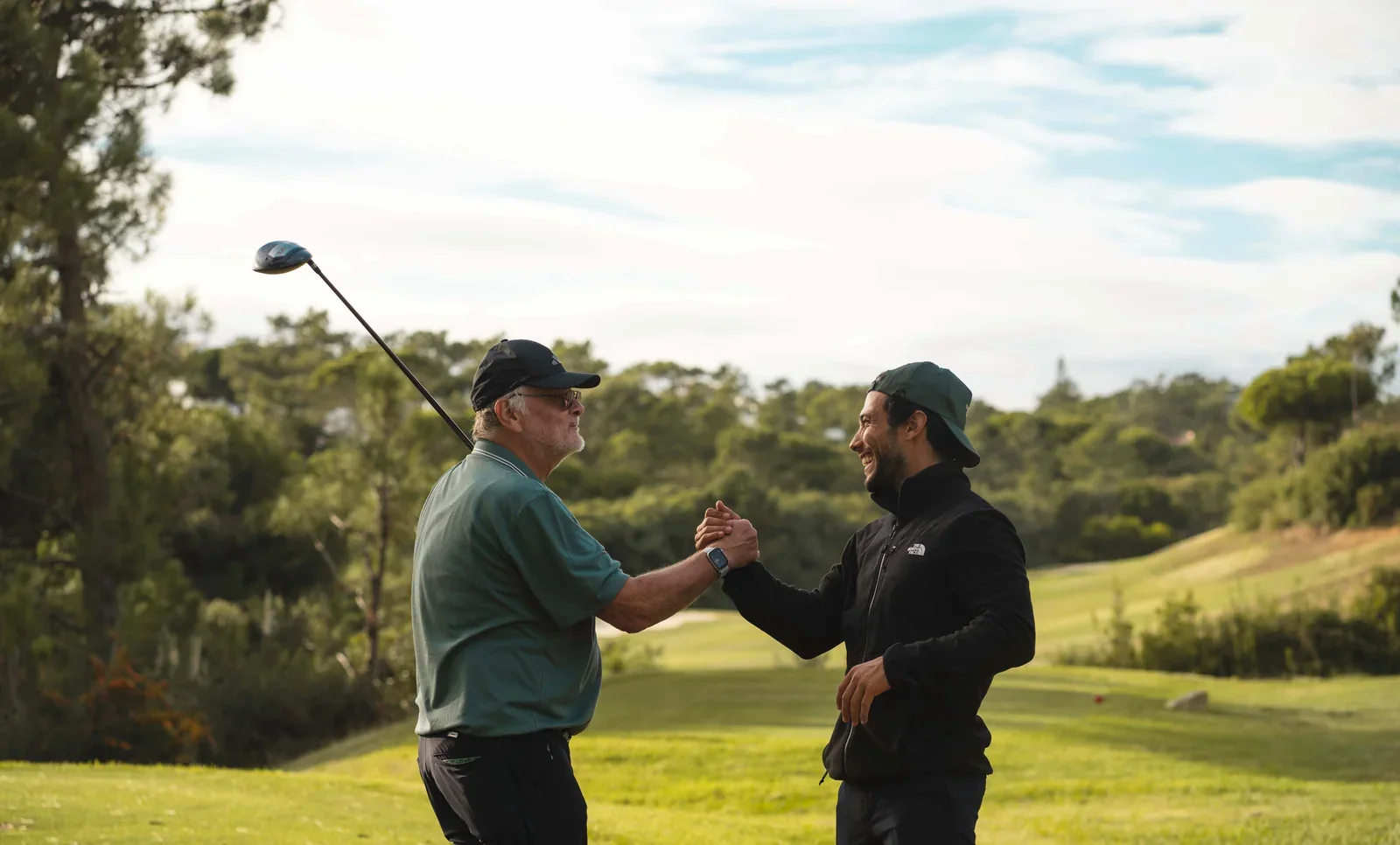 Golfer begrüßen sich herzlich auf dem Fairway, Vamos Golf Golfreise